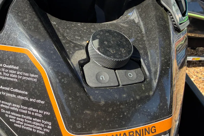 Slide: The Image of Close-up of 2023 Kawasaki Ultra dashboard with control knob and warning label. - 14