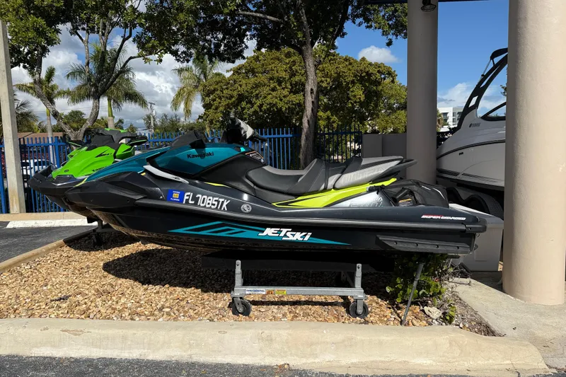 Slide: The Image of 2023 Kawasaki Ultra Jet Ski parked outdoors under a sunny sky. - 8