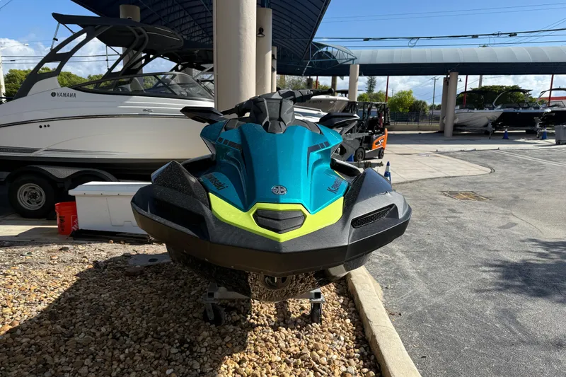 Slide: The Image of 2023 Kawasaki Ultra jet ski in a marina setting, vibrant blue and green design. - 9