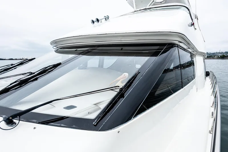 Slide: The Image of 2005 Carver 560 Voyager yacht with sleek design and large windows on the water. - 12