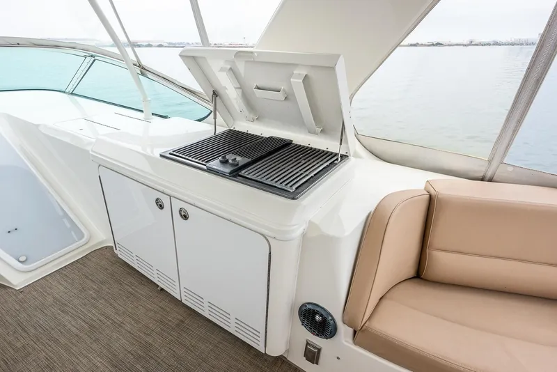Slide: The Image of 2005 Carver 560 Voyager yacht interior with grill and seating area. - 16