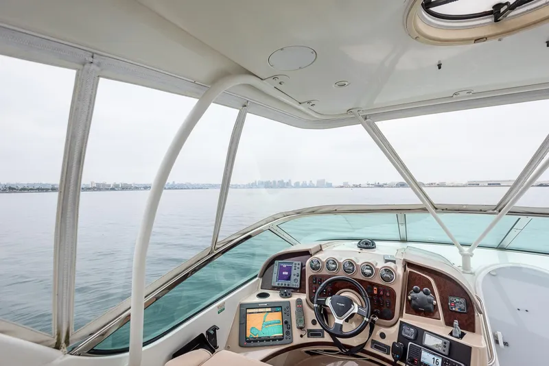 Slide: The Image of Interior view of 2005 Carver 560 Voyager yacht helm with city skyline in background. - 21