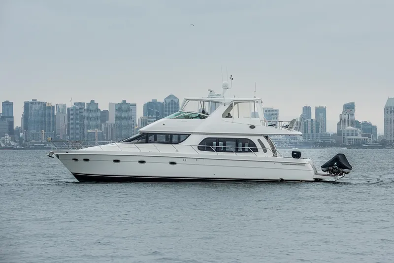 Slide: The Image of 2005 Carver 560 Voyager yacht on water with city skyline background. - 3