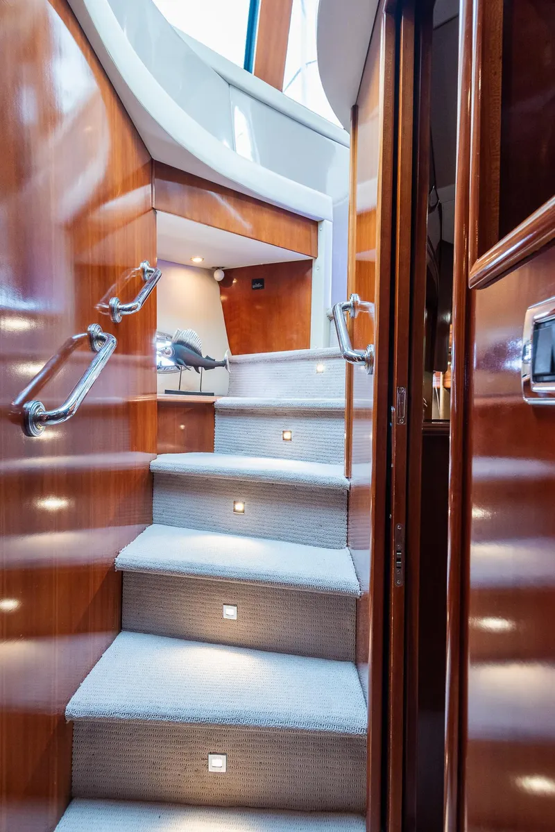 Slide: The Image of Interior staircase of 2005 Carver 560 Voyager yacht with wooden finish and carpeted steps. - 47