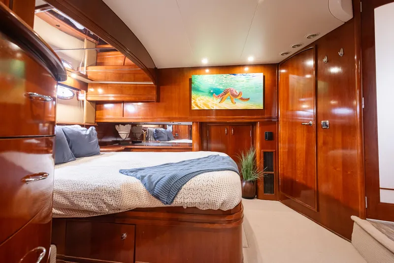 Slide: The Image of Luxurious 2005 Carver 560 Voyager cabin with elegant wood finish and cozy bedding. - 48
