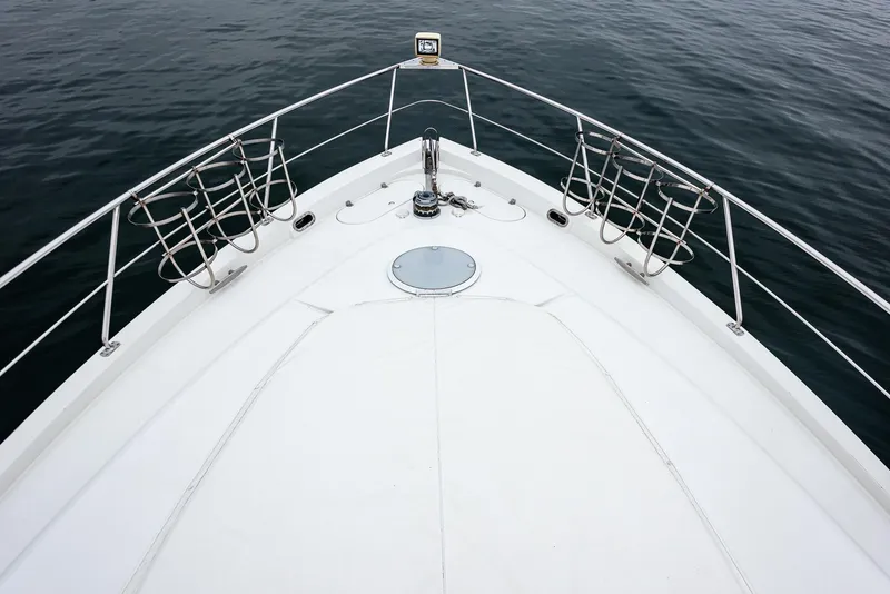 Slide: The Image of Bow of 2005 Carver 560 Voyager yacht on calm water. - 9