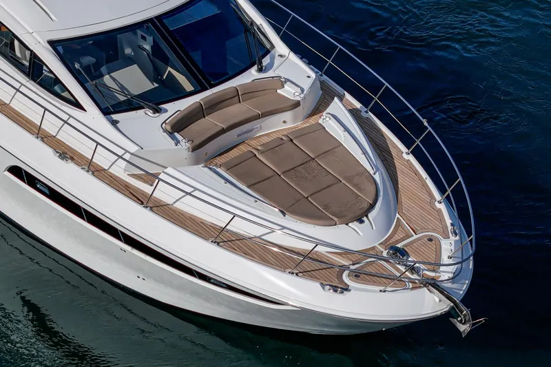Slide: The Image of 2016 Sea Ray L590 yacht with sleek design and spacious deck on water. - 13