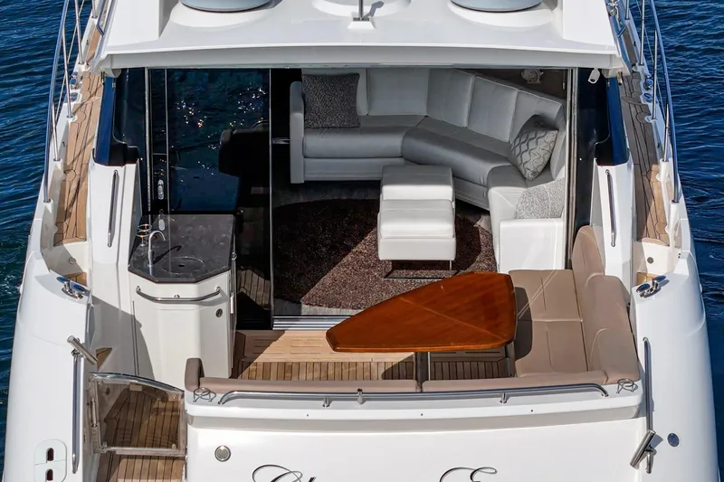 Slide: The Image of Luxurious 2016 Sea Ray L590 yacht with elegant seating and sleek design on the water. - 15