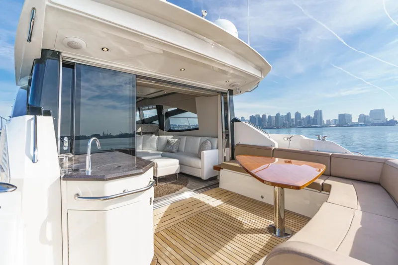 Slide: The Image of Luxurious 2016 Sea Ray L590 yacht with spacious deck and city skyline view. - 17