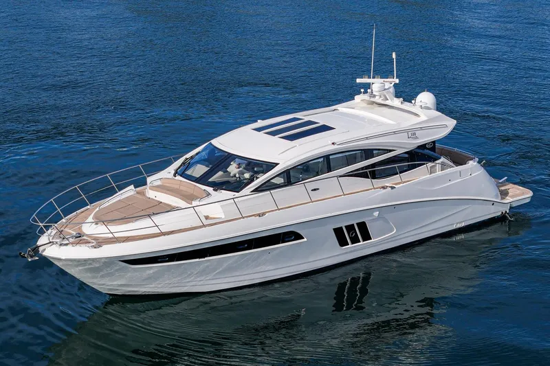 Slide: The Image of 2016 Sea Ray L590 yacht cruising on calm blue waters. - 2