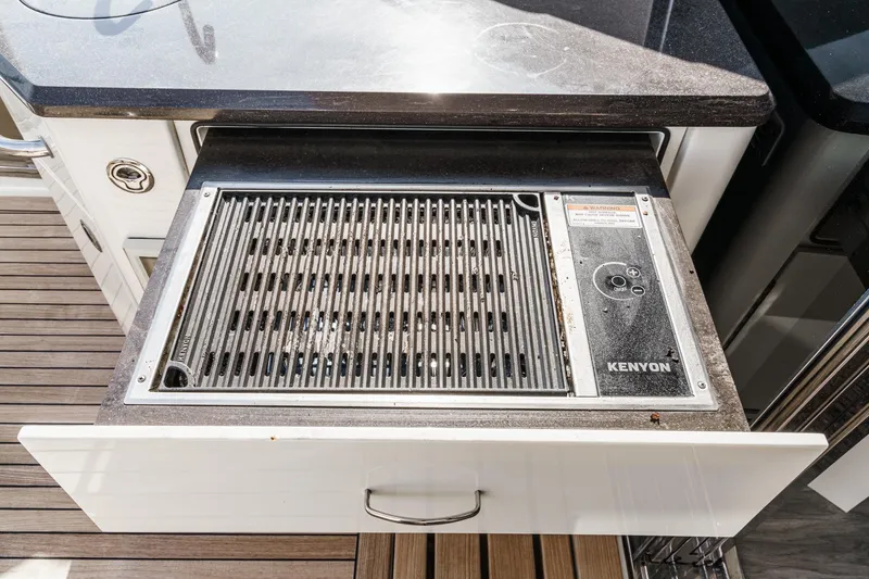 Slide: The Image of Built-in Kenyon grill on 2016 Sea Ray L590 yacht, featuring sleek countertop design. - 22