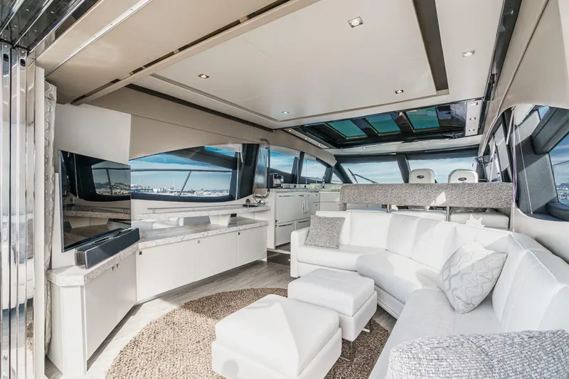Slide: The Image of Luxurious interior of 2016 Sea Ray L590 yacht with modern white seating and panoramic windows. - 26