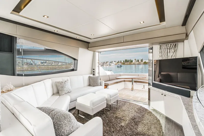 Slide: The Image of Luxurious interior of 2016 Sea Ray L590 yacht with white seating and waterfront view. - 28