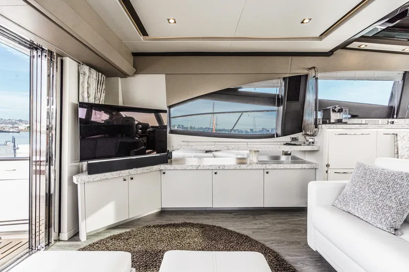 Slide: The Image of Luxurious interior of 2016 Sea Ray L590 yacht with modern furnishings and panoramic windows. - 29