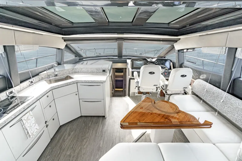 Slide: The Image of Luxurious interior of 2016 Sea Ray L590 yacht with modern kitchen and seating area. - 33