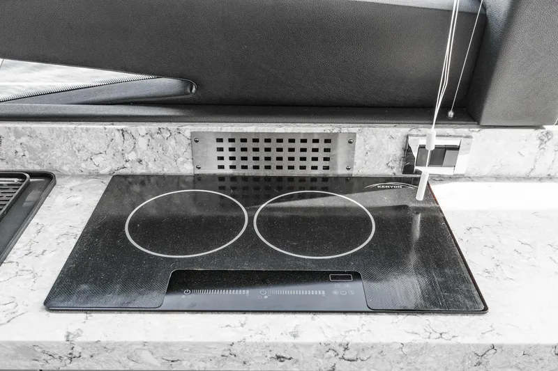 Slide: The Image of Modern induction cooktop on 2016 Sea Ray L590 yacht's marble countertop. - 37