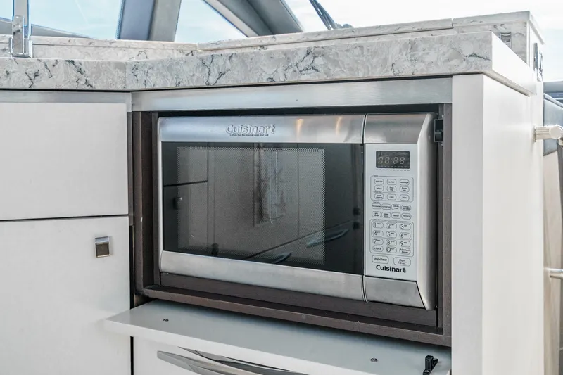 Slide: The Image of Cuisinart microwave in 2016 Sea Ray L590 yacht kitchen with marble countertop. - 38