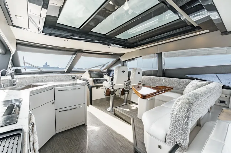 Slide: The Image of Luxurious interior of 2016 Sea Ray L590 yacht with modern seating and panoramic windows. - 39