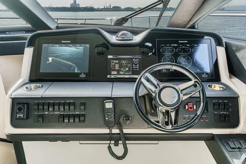 Slide: The Image of 2016 Sea Ray L590 helm with advanced navigation displays and controls. - 43