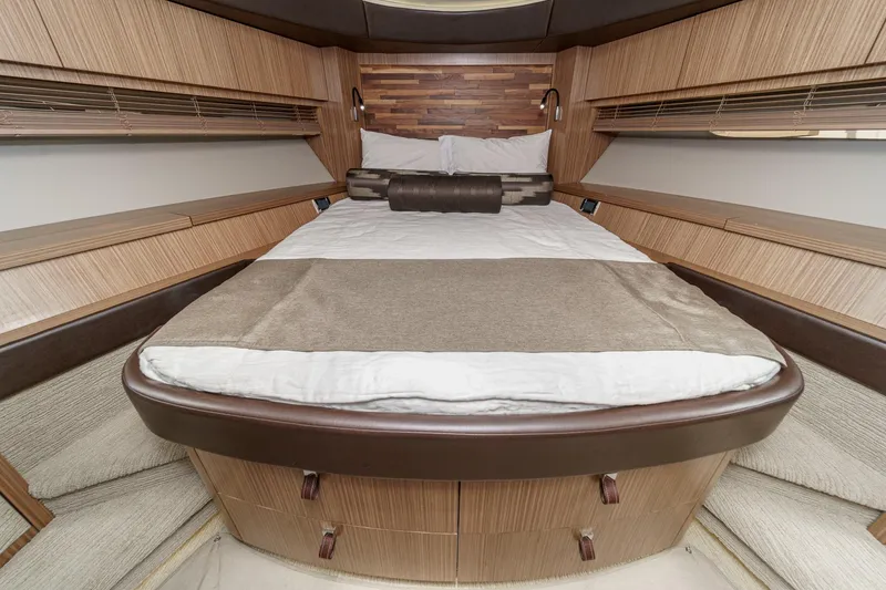 Slide: The Image of Luxurious 2016 Sea Ray L590 yacht bedroom with elegant wood finishes and cozy bedding. - 45