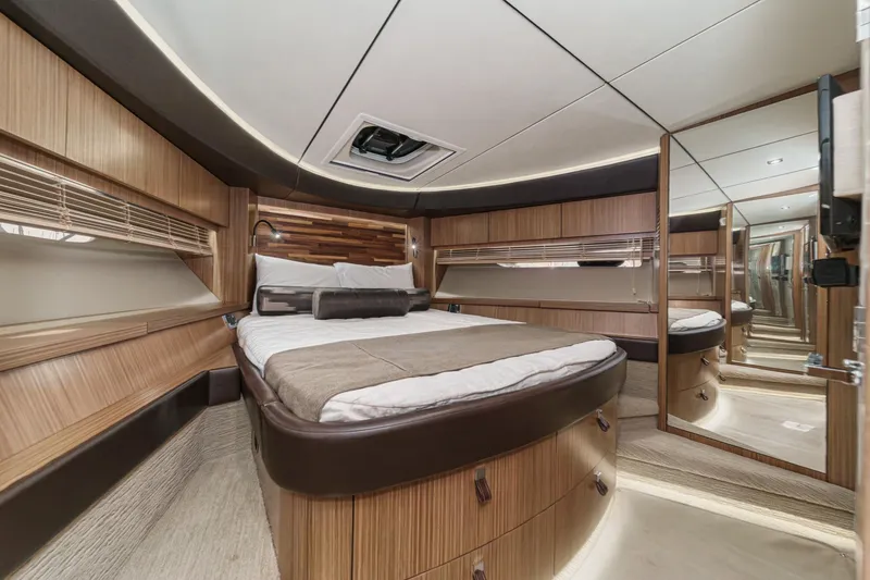 Slide: The Image of Luxurious 2016 Sea Ray L590 yacht bedroom with elegant wood finishes and modern design. - 46