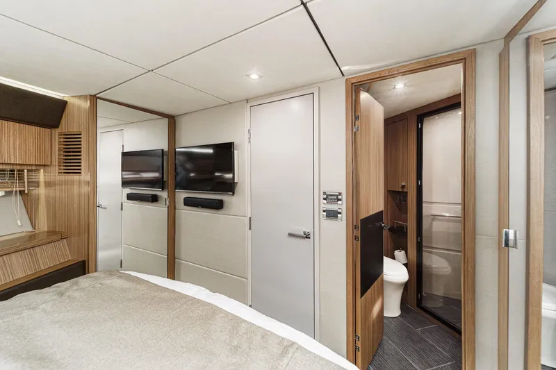 Slide: The Image of Luxurious 2016 Sea Ray L590 yacht interior with modern bedroom and ensuite bathroom. - 47