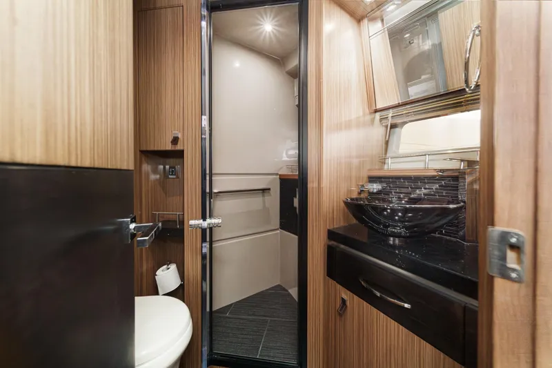 Slide: The Image of Luxurious bathroom interior of 2016 Sea Ray L590 yacht with modern fixtures and wood accents. - 48