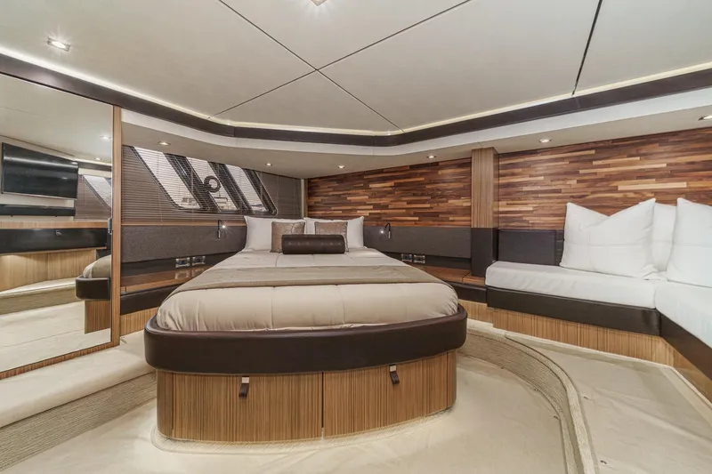 Slide: The Image of Luxurious 2016 Sea Ray L590 yacht bedroom with modern wood accents and elegant bedding. - 51