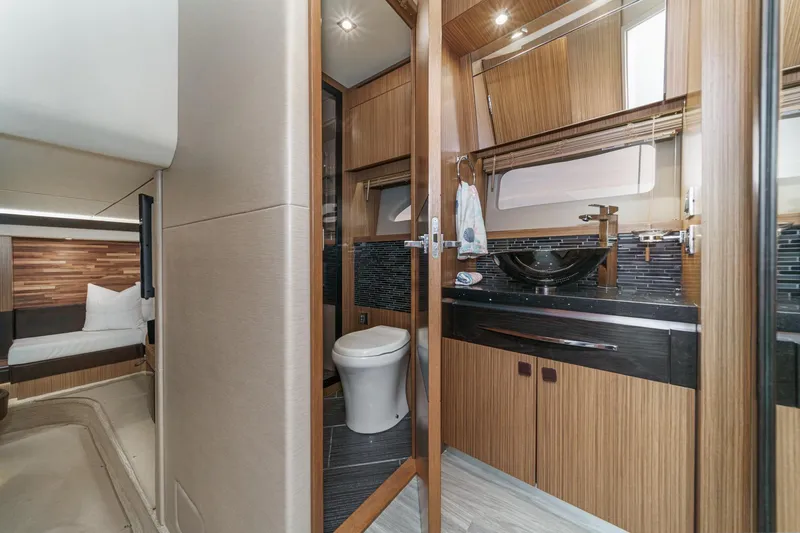 Slide: The Image of Luxurious 2016 Sea Ray L590 yacht interior with modern bathroom and cozy bedroom. - 54