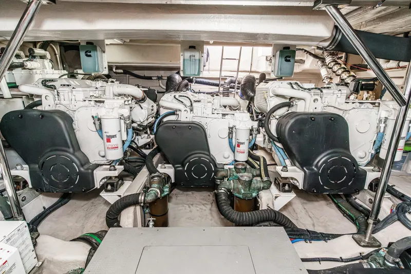 Slide: The Image of Engine room of 2016 Sea Ray L590 yacht, featuring three powerful engines. - 57