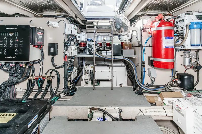 Slide: The Image of Engine room of 2016 Sea Ray L590 yacht, featuring electrical panels and fire safety equipment. - 61