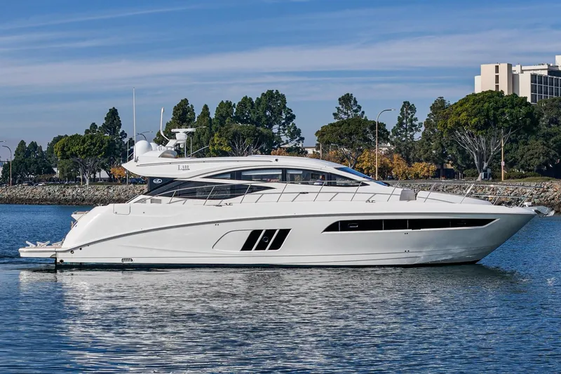 Slide: The Image of 2016 Sea Ray L590 yacht on calm water, surrounded by trees and buildings. - 8