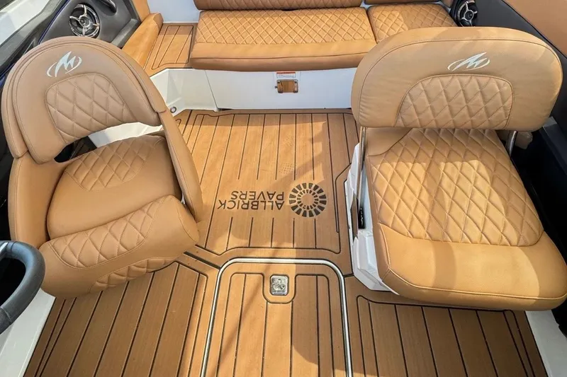 Slide: The Image of 2016 Monterey 218 Surf boat interior with tan leather seating and wood accents. - 10