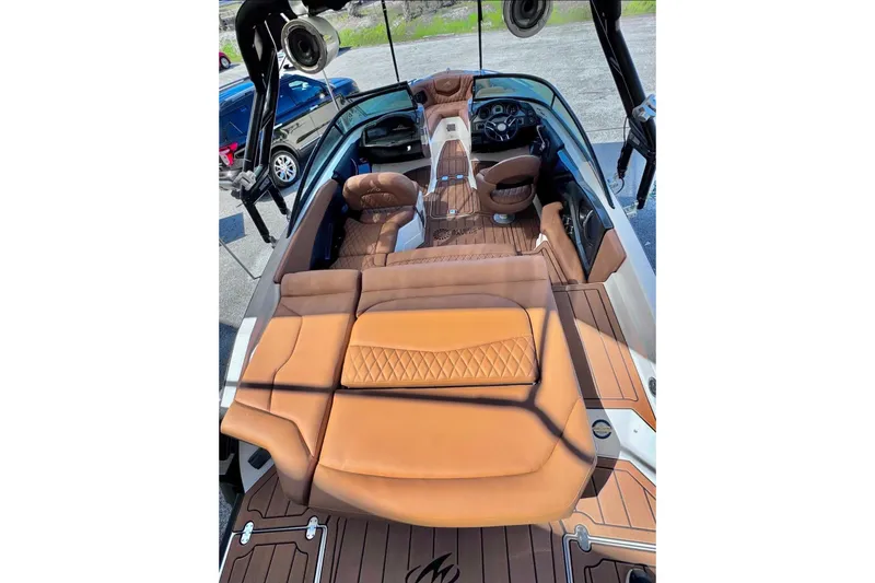 Slide: The Image of 2016 Monterey 218 Surf boat interior with tan seating and modern dashboard. - 11