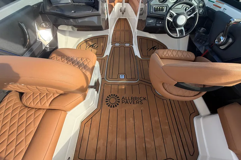 Slide: The Image of Interior of 2016 Monterey 218 Surf boat with tan leather seats and wood accents. - 15