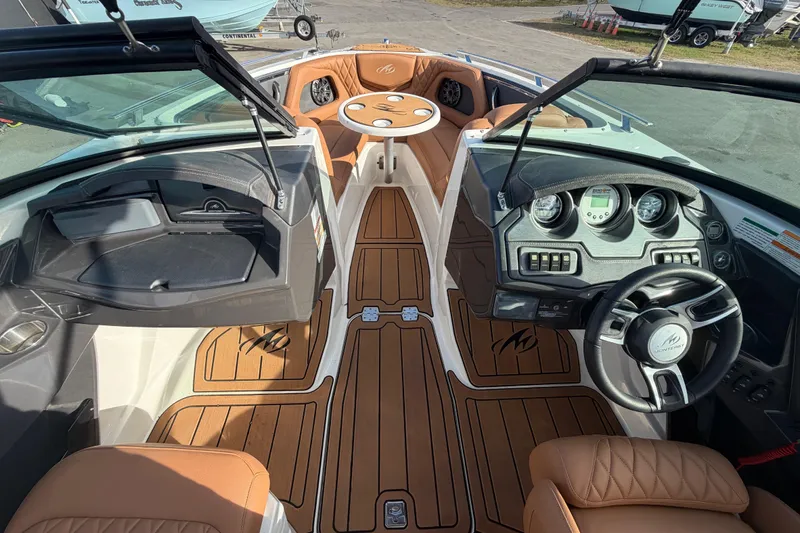 Slide: The Image of 2016 Monterey 218 Surf boat interior with steering wheel and tan seating. - 17
