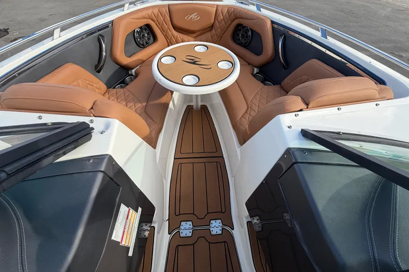 Slide: The Image of 2016 Monterey 218 Surf boat interior with tan leather seating and wood accents. - 20