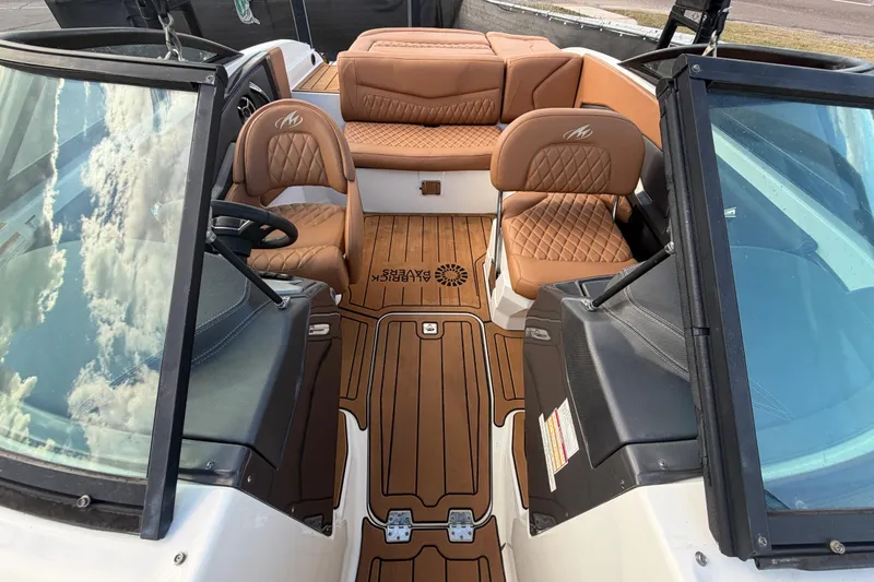 Slide: The Image of 2016 Monterey 218 Surf boat with tan leather seats and sleek windshield design. - 25