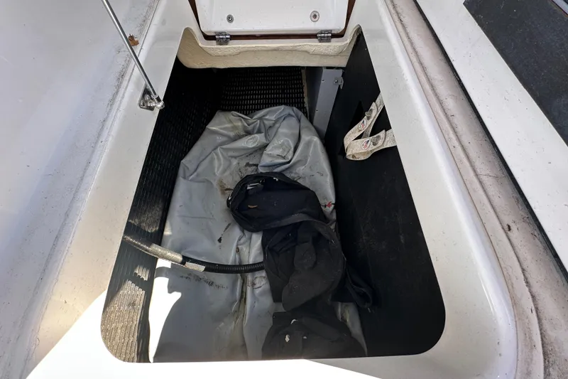 Slide: The Image of Open storage compartment in 2016 Monterey 218 Surf boat with items inside. - 36