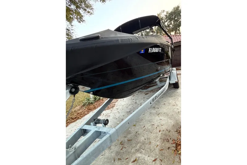 Slide: The Image of 2016 Monterey 218 Surf boat on trailer under clear blue sky. - 4