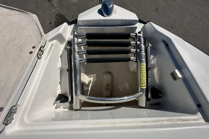 Slide: The Image of Foldable ladder on a 2016 Monterey 218 Surf boat, stored in a compartment. - 40