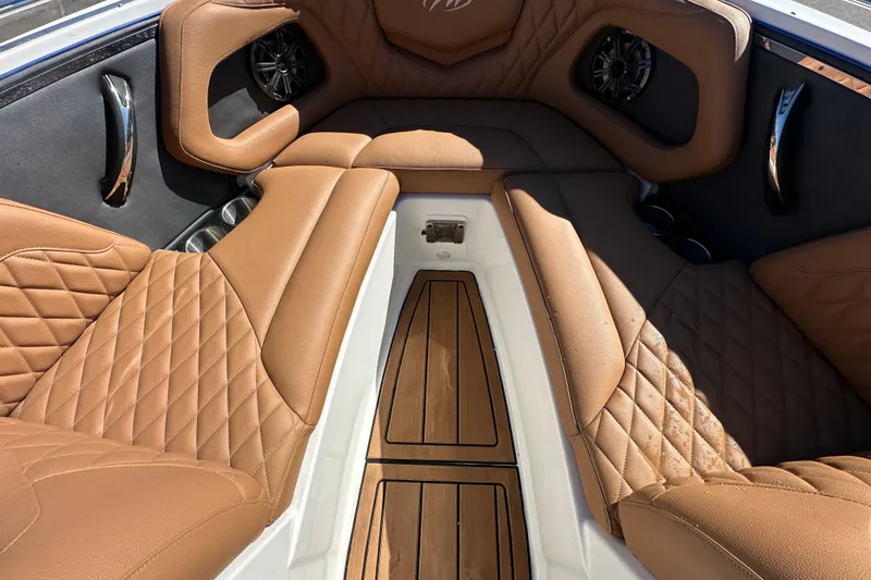 Slide: The Image of Luxurious interior of 2016 Monterey 218 Surf boat with tan leather seating and wood flooring. - 41