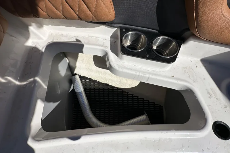 Slide: The Image of Storage compartment and cup holders in 2016 Monterey 218 Surf boat interior. - 43