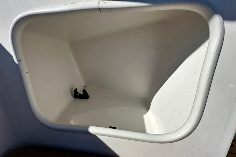 Slide: The Image of Storage compartment of a 2016 Monterey 218 Surf boat, white interior. - 48
