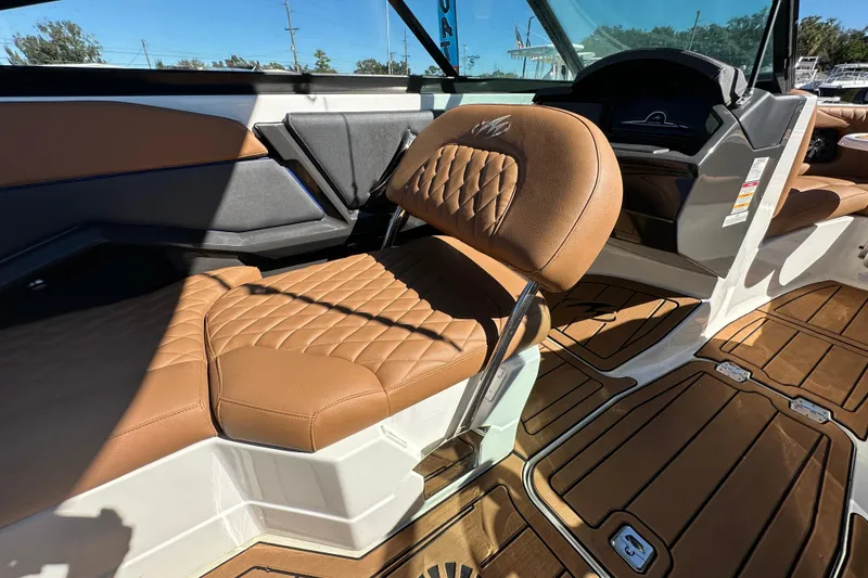 Slide: The Image of Luxurious interior of a 2016 Monterey 218 Surf boat with tan leather seating. - 59