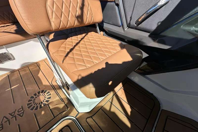 Slide: The Image of Brown leather seat on 2016 Monterey 218 Surf boat, featuring diamond stitching and wooden flooring. - 60