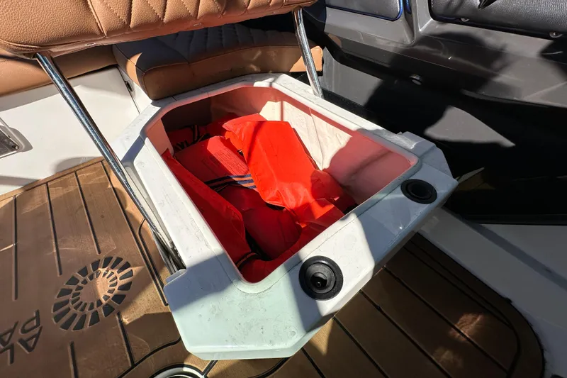 Slide: The Image of Storage compartment with life jackets on a 2016 Monterey 218 Surf boat. - 61