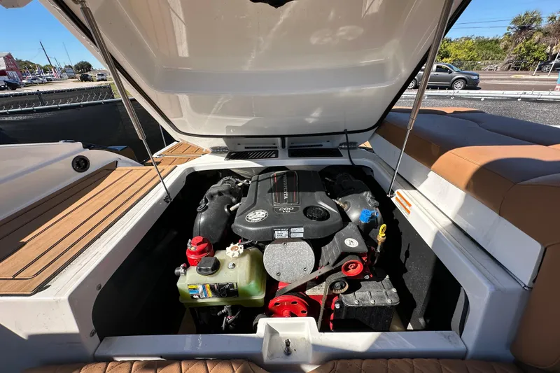 Slide: The Image of Open engine compartment of 2016 Monterey 218 Surf boat, showcasing engine components. - 70