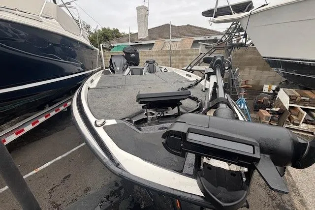 Slide: The Image of 2024 Skeeter FXR21 Limited boat in storage, showcasing deck and equipment. - 1