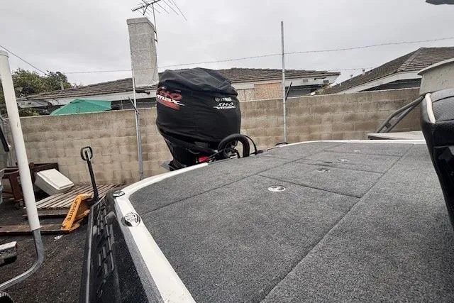 Slide: The Image of 2024 Skeeter FXR21 Limited boat with covered motor, parked outdoors. - 12